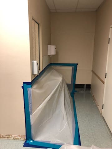 Poly barrier separating the work area from the corridor